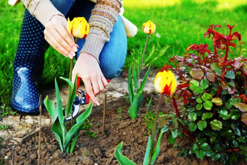 Gardener wearing PPE while carrying out garden maintenance